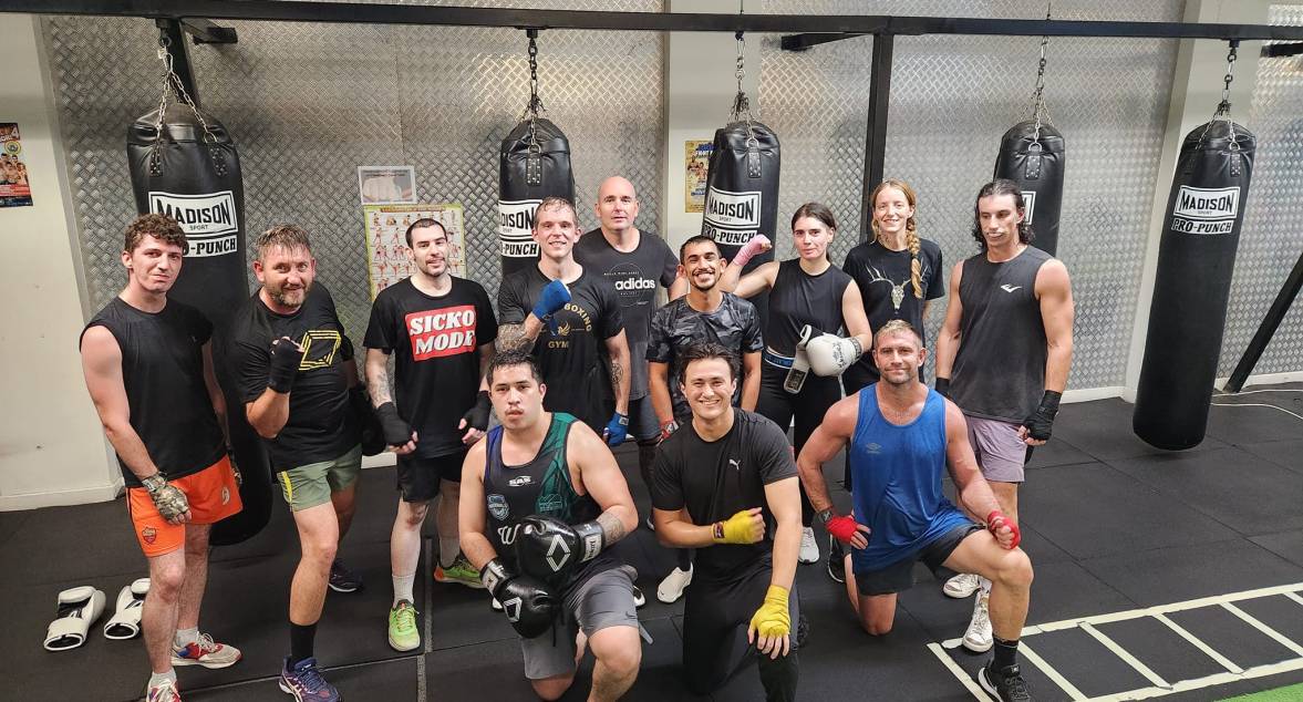 Group shot of happy people after martial arts training